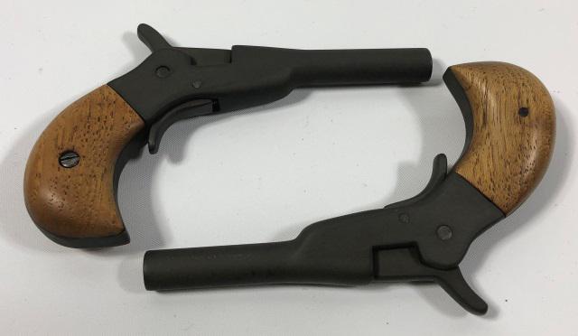 PAIR OF REPRODUCTION PISTOLS: Pair of reproduction small pistols, unmarked, steel with flat black finish and wood grips, with hinged box, approximate gun length 4 5/8".