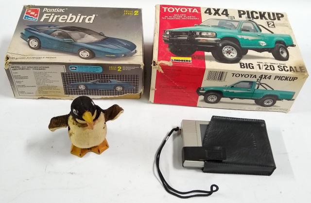 4 PIECES: 2 car models, Pontiac Firebird and Toyota 4X4 pickup, wind up penguin, and a miniature television.