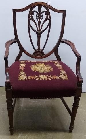 SHERATON STYLE ARMCHAIR: With shield shaped back, having floral needlepoint upholstered seat.