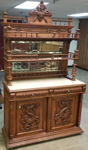 VICTORIAN WALNUT SIDEBOARD: The upper section having open shelves and mirrored back, lower section having inset marble over 2 drawers and 2 doors, decorated with mythical dragons, approximate height 87 1/2". width 53", depth 20 