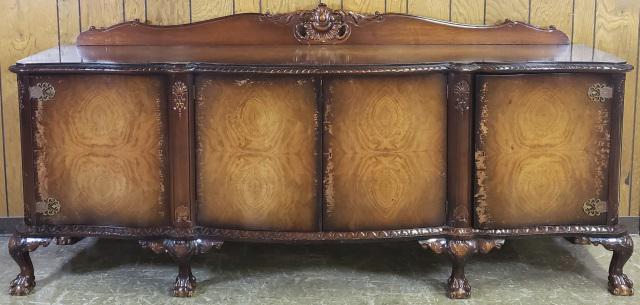 LARGE SIDEBOARD: Having 2 center doors opening to 2 shelves, and 2 outer door, right door opening to 4 drawers, left opening to 2 shelves, raised on ball and claw feet, complete with 2 keys, approximate height 44 3/4"