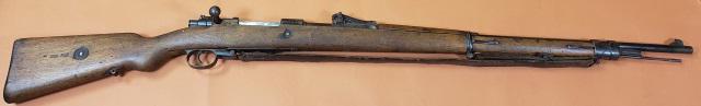 GERMAN MAUSER RIFLE: Circa 1918, German Mauser rifle, Model Gewehr 98, 7.92 cal, S/N #4090. Bolt action. Walnut full stock. Section of barrel in front of rear sight covered by full walnut stock, unidentified symbols inclu