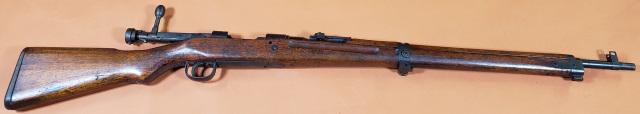 JAPANESE RIFLE: Circa 1941 Japanese rifle type 99, 7.7 mm, serial #12497 on left side of breech, walnut stock, single shot, folding leaf sight, 2 sling swivels, bayonet holder, metal butt plate. collected as a souven