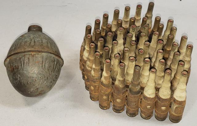 2 PIECES: Circa 1968, Round of machine gun ammo, 51 blank cartridges, linked together w/metal "chain", one missing from end, along with a Circa 1916, French OF1 hand grenade, egg-shaped metal container w/thread
