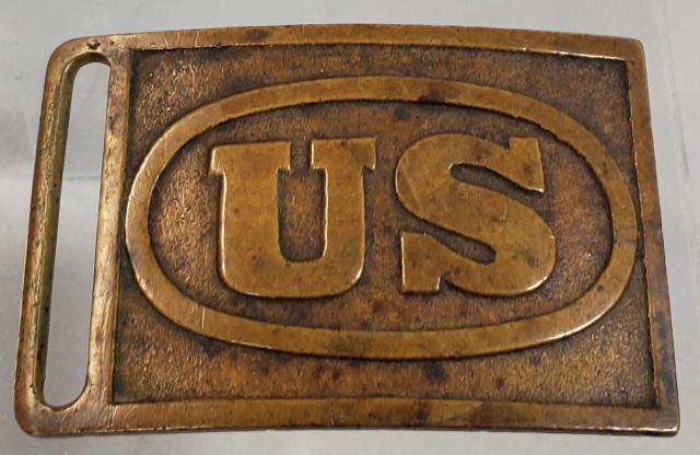 CIVIL WAR SWORD BELT BUCKLE: Circa 1898, U.S. Army uniform cast brass buckle, Model 1874. Rectangle with oval and "US" in center, U.S. Army sabre belt buckle, first used by cavalry & mounted artillery, worn for dress by all branc