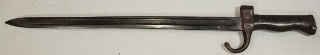 SWORD BAYONET: Circa 1918, sword bayonet, possibly French. Hilt has smooth wooden grips & metal pommel w/spring catch for attaching to a rifle. Metal up-turned quillon above hilt, side stamped "T.23712", "P" stamped