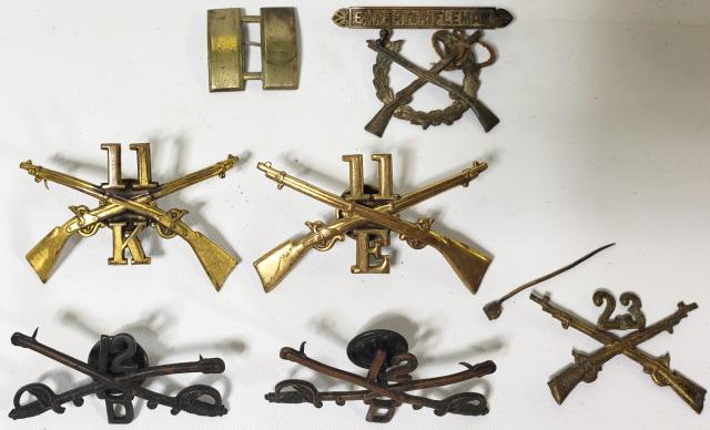 GROUP OF MILITARY PINS: Circa 1898, U.S. Infantry hat badge, 11th Regiment, Co. K. Brass with crossed rifles, screw back, Circa 1898, U.S. Army Infantry hat pin; 23 over two crossed rifles; brass, Circa 1890, U.S. Army brass