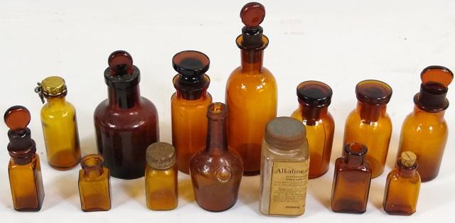 14 VINTAGE BROWN GLASS BOTTLES: 8 with covers or stoppers.