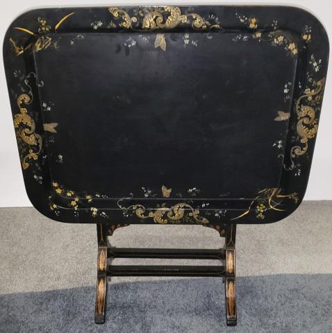 VICTORIAN TILT TOP SIDE TABLE: Having ebony finish and gilt highlighting of leafy scrollwork, approximate height 24 1/2", height open 34" width 30", depth 23 1/4".