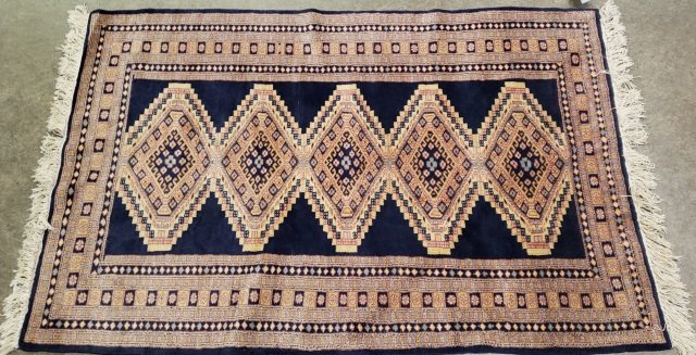 HANDMADE WOOL RUG: Marked made in Pakistan, Kafkazi Blue design, approximate size 59" x 38".