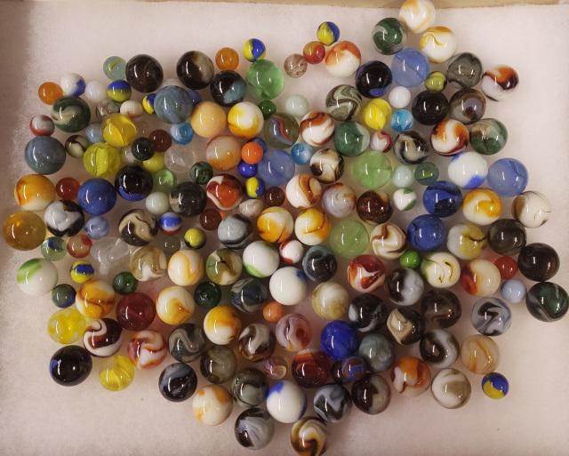 GROUP OF MISCELLANEOUS MARBLES: Glass marbles in 1 large container.