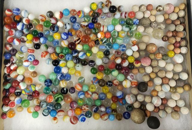GROUP OF MISCELLANEOUS MARBLES: Glass and clay marbles in 4 containers.