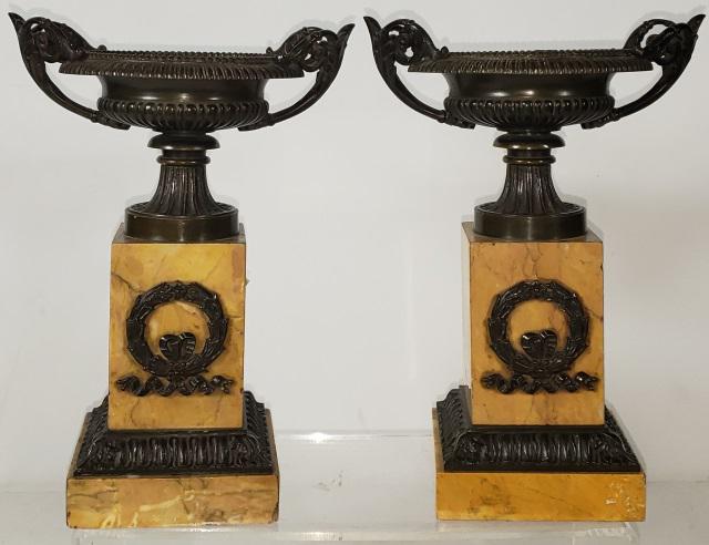 PAIR OF ANTIQUE BRONZE AND MARBLE PIECES: Possibly originally clock flanks, 2 handled urns raised on marble bases, having ormolu mounted decorations, approximate height 10 1/2".