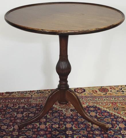 19TH C. GEORGIAN STYLE TILT TOP TABLE: Having circular top raised on tripod base, approximate height 23 1/2", diameter 23".