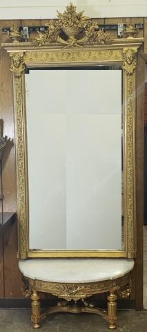 VICTORIAN PIER MIRROR: Mirror decorated with flowers and urn, mirror rests above marble shelf on gilt carved wood stand, 80" x 39", marble shelf 38" x 16".