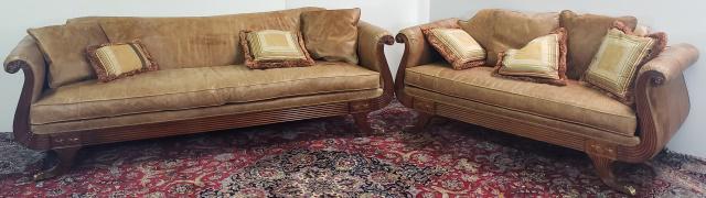 2 PIECES: Duncan Phyfe style sofa, having scroll arms, brown leather upholstery, raised on lion paw feet, together with matching settee.