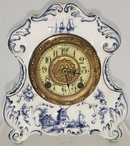 BLUE & WHITE MANTLE CLOCK: Decorated with Dutch scenes, complete with pendulum, approximate height 8", width 7 3/4", depth 3".