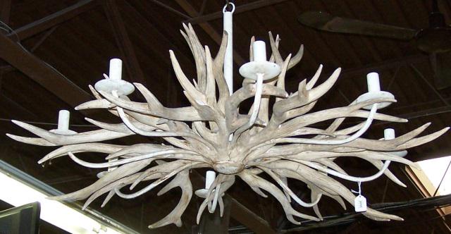 WESTERN STYLE HANGING LIGHT FIXTURE: Carved wood antler form, having 8 branches, approximate diameter 48".