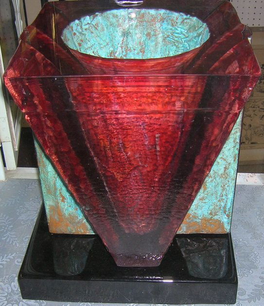 ***JOHN LEWIS ART GLASS VASE: Tapered cylindrical form with fused copper interior, shaded cranberry to copper with black glass base, approximate overall height 13 3/4''.