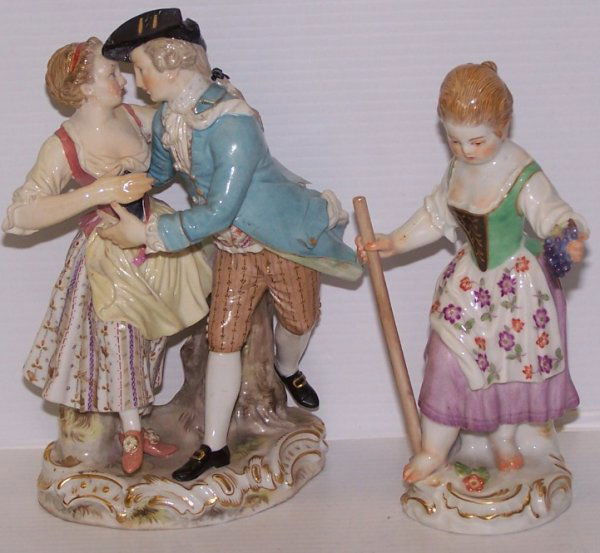 ***TWO MEISSEN PORCELAIN FIGURES: Depicting dancing couple, base having Meissen blue crossed swords mark under glaze, approximate height 6'', together with young lady holding grapes, approximate height 5 1/4''.