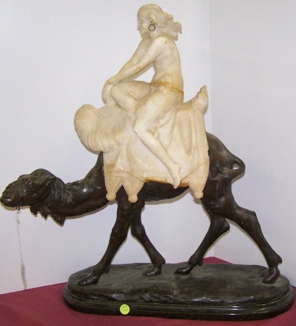 CONTINENTAL BRONZE AND ALABASTER SCULPTURE: Carved alabaster semi-nude lady mounted on a bronze camel, raised on a green marble base, approximate height 23''.