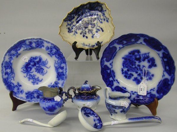 ***EIGHT PIECES OF FLOW BLUE: Leaf form bowl marked S.& B.T. ''Primrose'' pattern, Samuel Alcock shallow bowl ''Carlton'' pattern, Ridgeway & Morley shallow bowl ''Cashmere'' pattern, La Bell creamer with pewter lid, New Wharf pot
