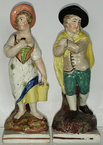 2 PEARLWARE FIGURES: Depicting man with black hat & yellow cape, and woman with basket of flowers, tallest is 7 5/16".