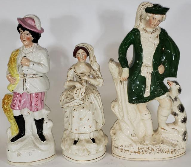 3 STAFFORDSHIRE FIGURES: Depicting man in green with dog & rifle, approximate height 14 1/2", man with wheat, 13 3/4" and woman with instrument, 10 7/8".