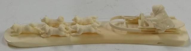 BONE SCULPTURE: Dogs pulling sled, approximate length 8".