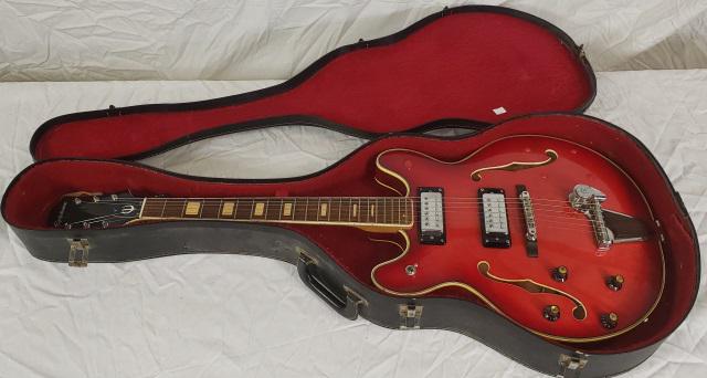 EPIPHONE ELECTRIC GUITAR: Epiphone electric guitar, left handed, style EA-250, has steel adjustable neck, with case and strap. (Converted to left handed, original holes for volume and tone knobs are now plugged.)