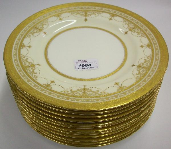 ***SET OF TWELVE MINTONS SERVICE PLATES: Having gilt decoration against a cream and white ground, approximate diameter 10 1/2''.