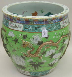 ***CHINESE PORCELAIN JARDINIERE: Having dragon, floral and leaf decoration against a green ground, further enhanced with bird and flowering branch motif, approximate height 16 1/2'', diameter 17''.