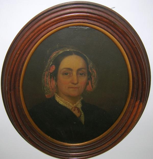 ***IN THE MANNER OF THOMAS SULLY: Portrait of a woman with cameo, an oval formed and framed oil on canvas, mounted under glass, unsigned, bears a stamp on the back of the canvas ''W.E. Rogers 16 Arcade Street, Philadelphia'', approxim