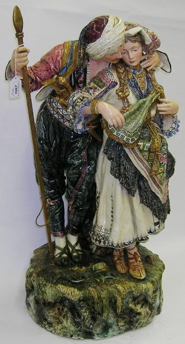 ***ITALIAN FAIENCE FIGURAL GROUP: Depicting lady and gentleman, raised on earth form base, approximate height 30".