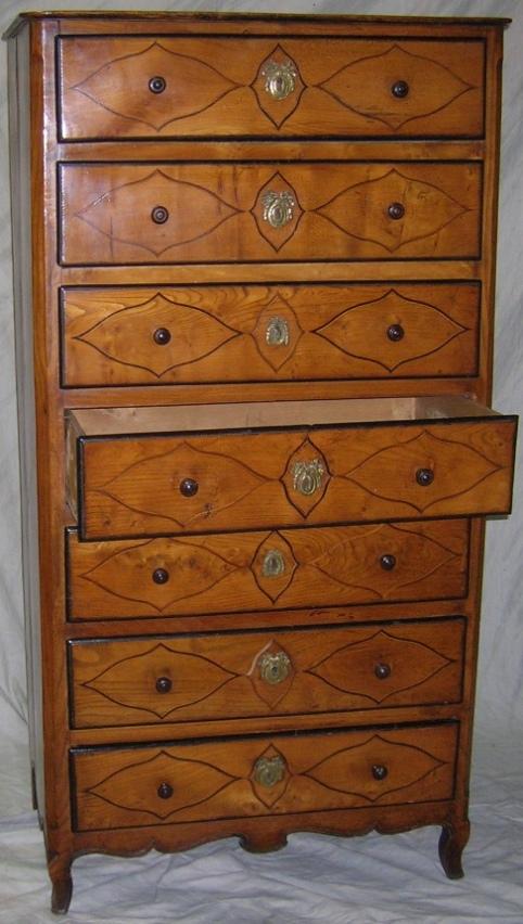 ***18TH CENTURY TALL CHEST: Fitted with 7 drawers, each having inlaid decoration and ebony borders with bowed ribbon escutcheons, approximate height 63 1/2", width 32 1/2, depth 17".