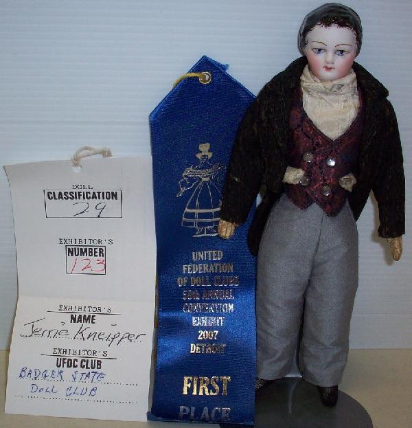PARIAN FRENCH BOY DOLL: Having painted features with black hair, on cloth body with leather stitched hands, has 1st place ribbon from 2007 Detroit convention, has original receipt for $1,500 from 1993, comes from the estate 