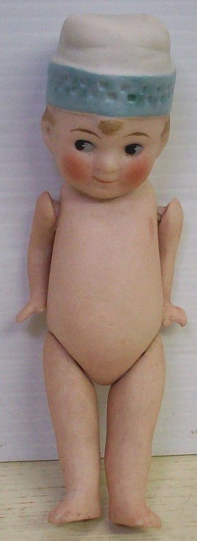 ALL BISQUE DOLL: Boy with molded blue and white hat, marked on back ''3/0'', comes from the estate of Geraldine (Jerrie) Kneipper, Kenosha, WI, member of ''The Badger State Doll Club'', approximate height 4 1/2''.