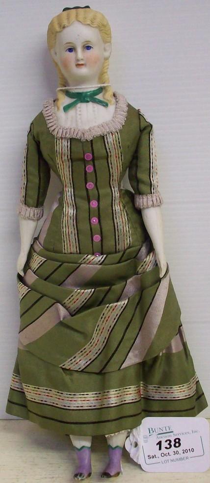 PARIAN HEAD DOLL: Having blue eyes and long blonde hair with curls, molded blouse, on cloth body with porcelain half-arms and legs with painted shoes, comes from the estate of Geraldine (Jerrie) Kneipper, Kenosha, WI, 