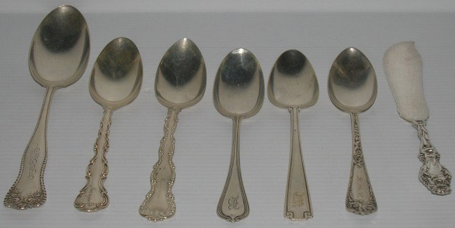 ***THIRTY-TWO PIECES OF STERLING SILVER FLATWARE: Various makers and patterns, comprising teaspoons, serving spoon, and butter knives.
