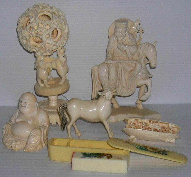 GROUP OF ORIENTAL CARVED IVORY: Depicting elder on horseback, approximate height 5'', puzzle ball on elephant form stand, height 6'', horse, height 2 3/4'', seated Buddha, height 2 1/2'', shell form sculpture, interior having carved