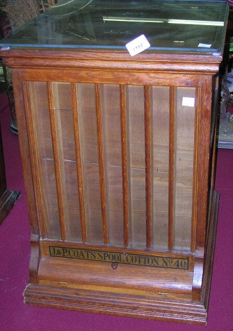 J. & P. COATS OAK SPOOL CABINET: Having hinged top and tamboured doors on sides, approximate height 23'', width 16 1/4'', depth 17''.