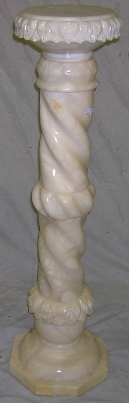 ***CARVED ALABASTER PEDESTAL: Having circular top raised on spiral turned shaft ending in octagonal base, approximate height 41''.