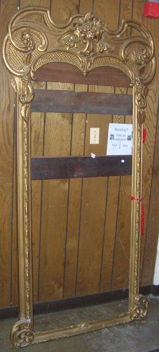 ***VICTORIAN GILT PIER MIRROR FRAME: Decorated with fruit, leaves and scrollwork, approximate height 83 1/2'', width 44'', with marble top stand.