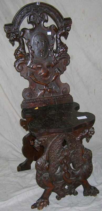 19TH CENTURY OAK HALL CHAIR: Having heavily carved frame decorated with dragons, flora, etc., approximate height 41 1/2'', width 15'', depth 19.
