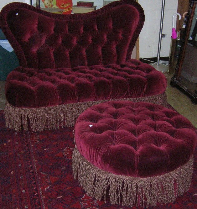 ***THREE PIECES BY CENTURY: Pair of settees with tufted burgundy upholstery, approximate height 41'', width 62'', depth 37'', together with matching ottoman, height 16'', diameter 34''.