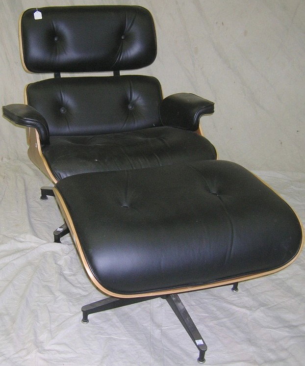***CHARLES AND RAY EAMES LOUNGE CHAIR AND OTTOMAN: In rosewood and black leather, manufacture date 2005.