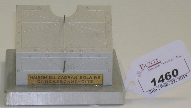 ***TWENTIETH CENTURY CAST METAL FRENCH TABLE TOP: ***TWENTIETH CENTURY CAST METAL FRENCH TABLE TOP SUNDIAL| Marked ''Maison du Cadran Solaire'', approximate size 3 1/4'' x 3'' x 2 1/4'', marked with sticker label on front.