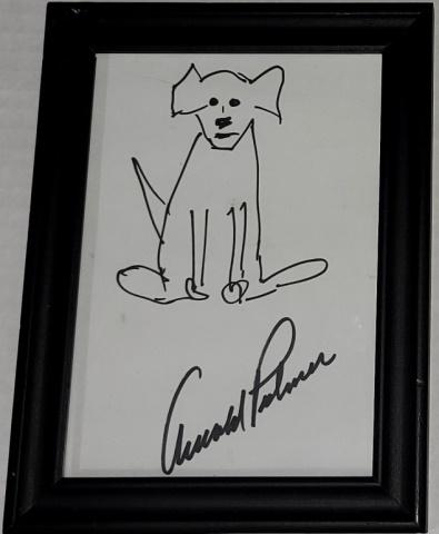 ARNOLD PALMER AUTOGRAPH: Framed Arnold Palmer autographed piece of paper, signed on lower portion and has drawing of dog above, frame 8 1/4" x 6 1/8".