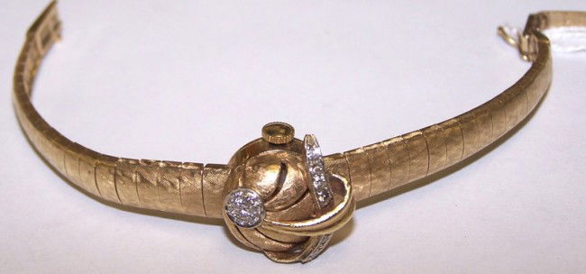 LADY'S LONGINES 14K YELLOW GOLD AND DIAMOND WRIST: Having jeweled movement, stem wound and set, with bar markers on silver finish dial, marked ''Longines'', contained in 14K yellow gold and diamond concealed case, set with 13 small round cut diamonds