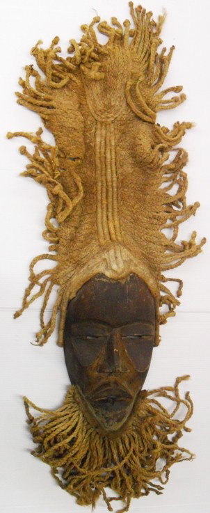 ***CARVED WOODEN MASK: From Dann tribe, made from wood and rope, having long rope headdress and beard, approximate length with rope 32''.